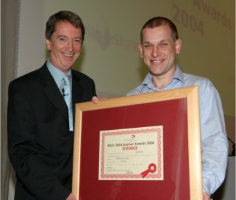 Paul Burke is presented with his award for the Work based category